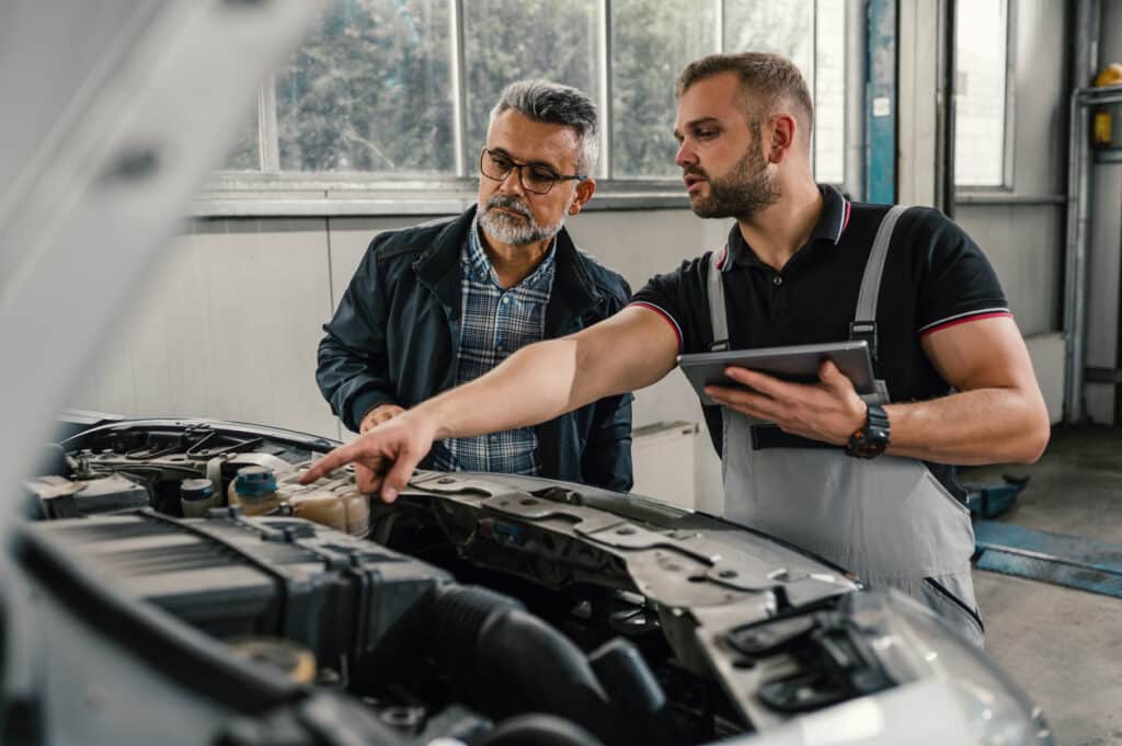 Auto mechanic with customer