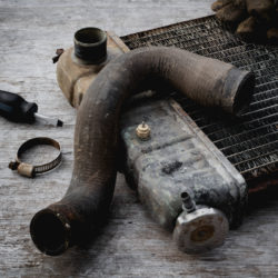 Old vehicle radiator on wooden repair table