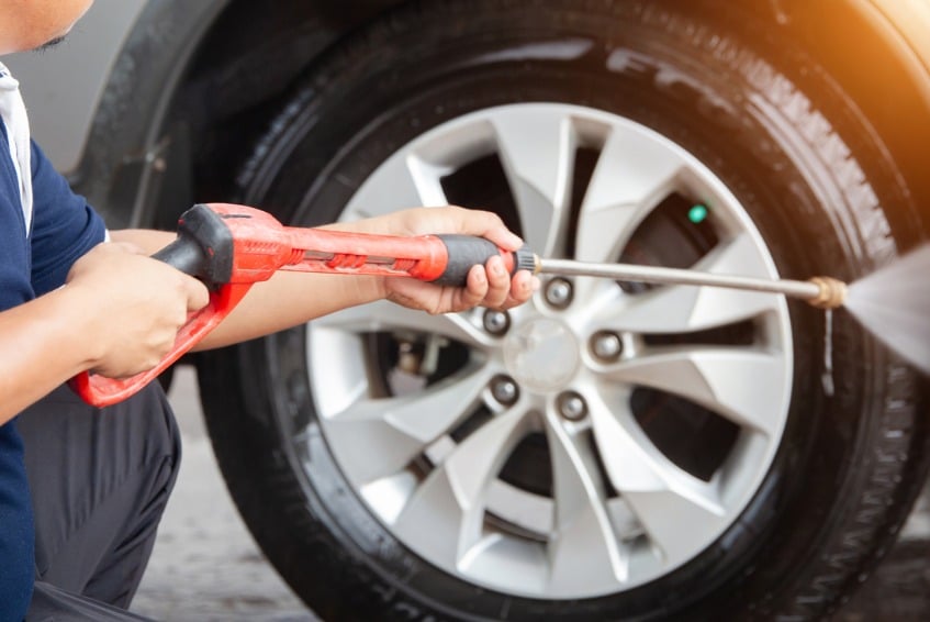 Man cleaning tires