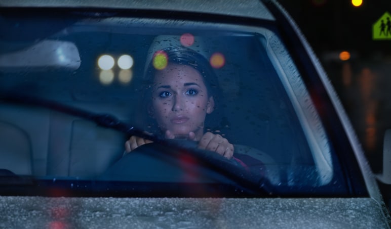 Young woman driving in rain