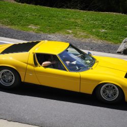 Spa, Belgium - June 29, 2008: Yellow classic Lamborghini Miura S sports car driving on a country road. Two persons are sitting in the car.
