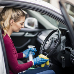 woman cleaning steering wheel