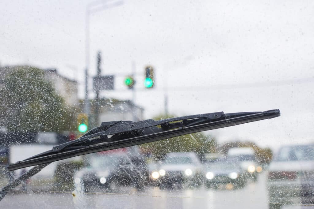 Windshield wipers from inside of car, season rain.