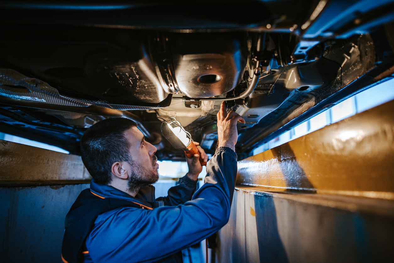 mechanic fixing exhaust