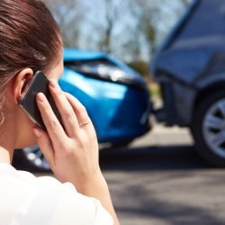 Female Driver Making Phone Call After Traffic Accident