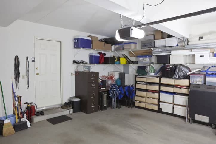 Simi untidy suburban garage with shelves and storage.