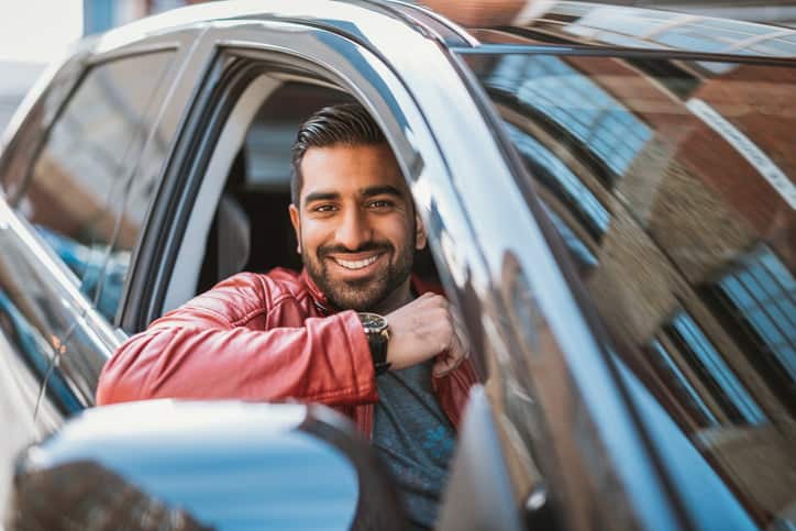 Indian man driving luxury taxi