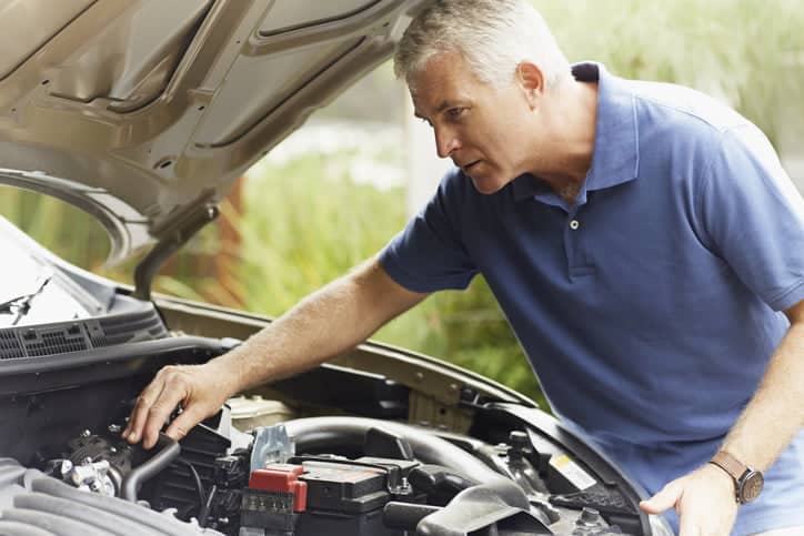 Man working under car bonnet