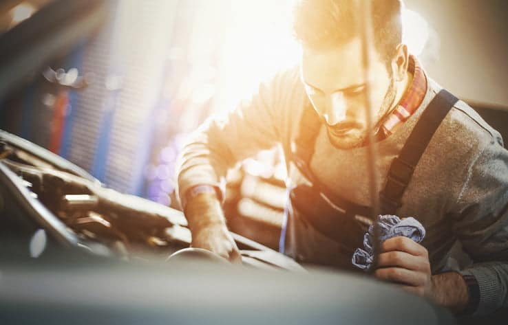 man fixing car