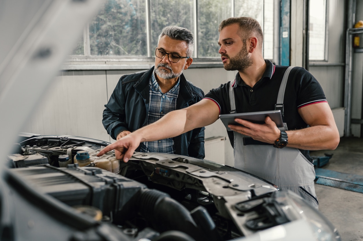 mechanic talking to car owner