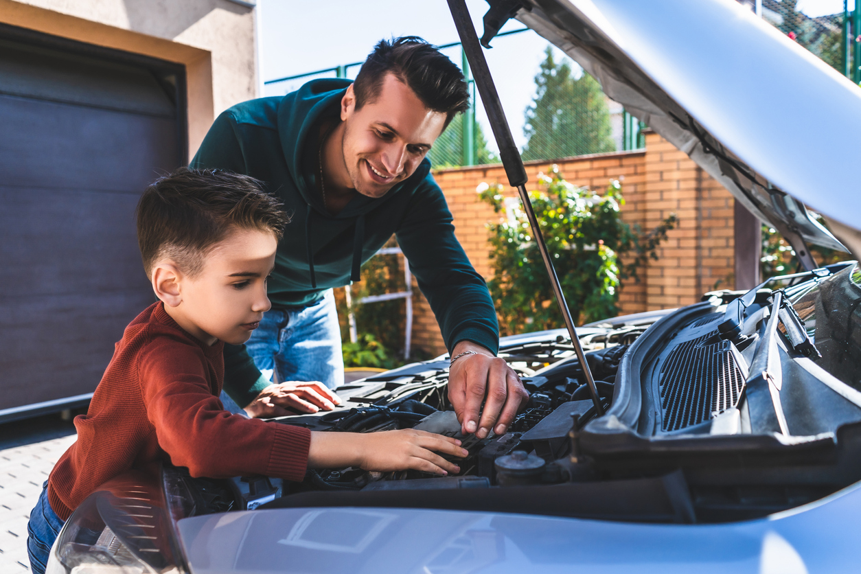 father and son repairing car