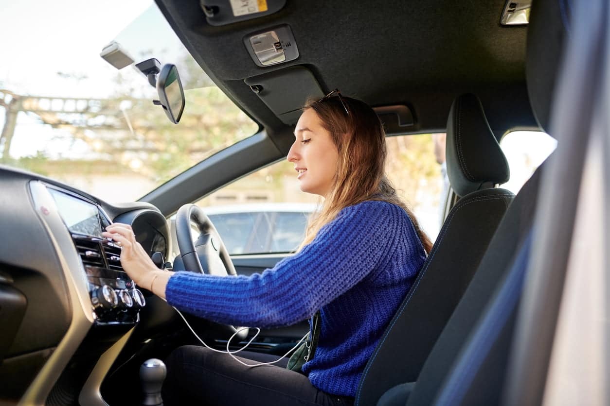 Shot of a young woman driving a car