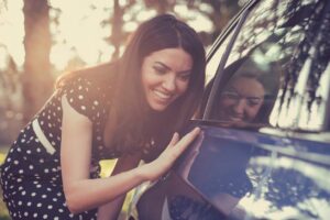 excited woman with car