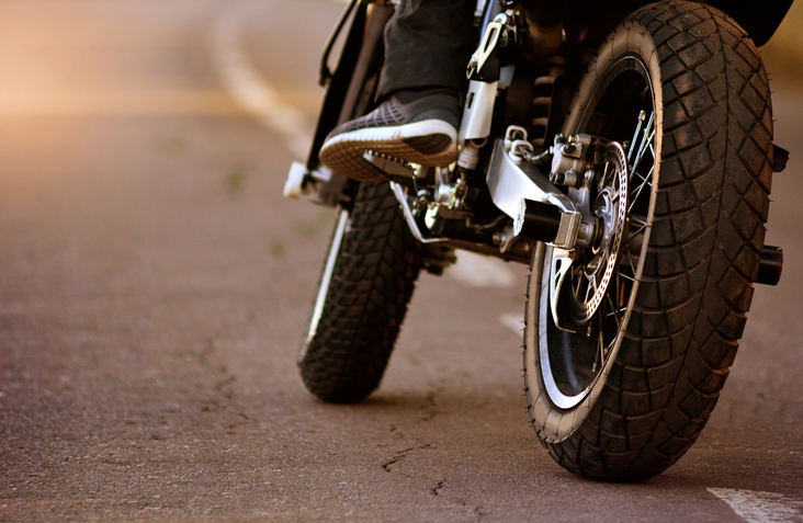 Motorcycle with biker on the asphalt road. Motorbike traveling concept.