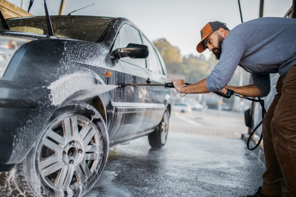 man washing his car