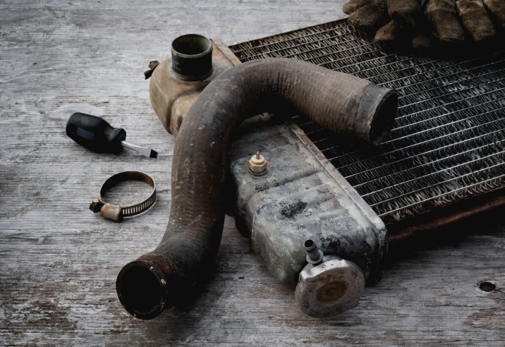 Old vehicle radiator on wooden repair table