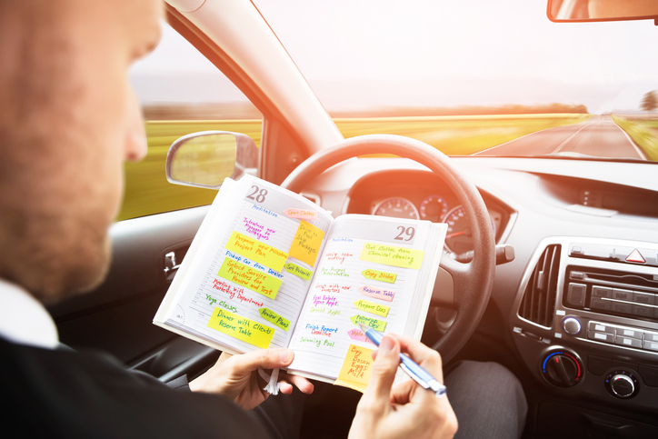 Driver Reading their Diary in the Car