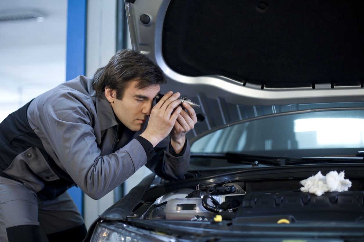 image of mechanic checking antifreeze