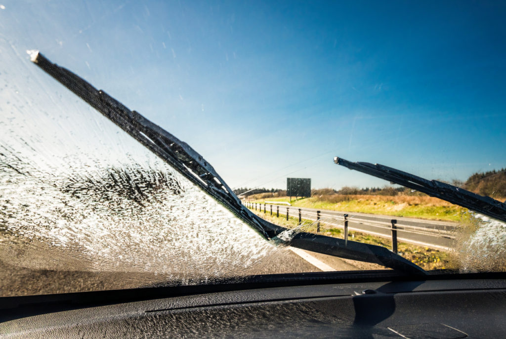 clearing windscreen with screen wash