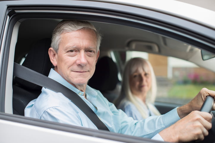 Portrait Of Smiling Senior Couple On Car Journey Together