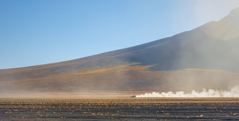 A four wheel drive vehicle cruising through the altiplano of Bolivia near the Uyuni salt flat and the Atacama desert in Chile, South America.