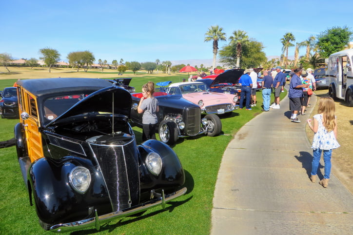 Palm Springs, California, United States - January 27th, 2019: People at charity car show admiring rows of classic, hot rod and special interest cars parked at a golf course in Palm Springs, California