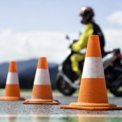 Focus Shot of Traffic Cones with a Motorbike in the Background