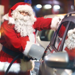 Santa Claus putting petrol in his car