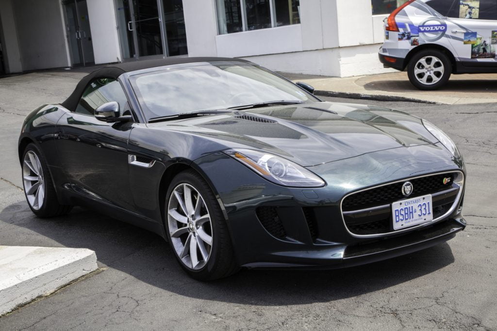 Halifax, Nova Scotia, Canada - June 23, 2013: A Jaguar F-Type convertible parked outside a car dealership. Neighboring Volvo dealership and Volvo SUV visible in background. The Jaguar F-Type is a two-seat convertible launched in 2013 by Jaguar. It is available with three engine configurations including two V6 and a V8. (as of 2013)