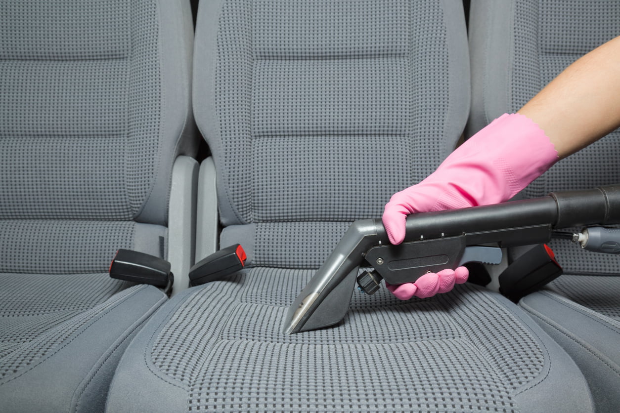 image of vaccuming a car seat