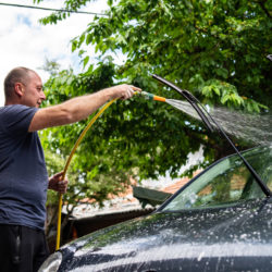 man washing his car