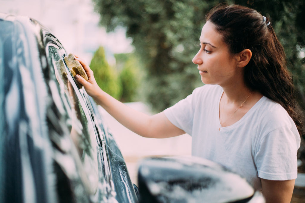 Woman washing her car