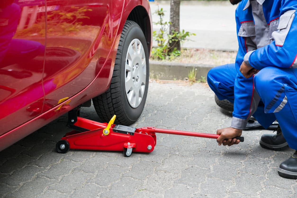 image of mechanic using jack