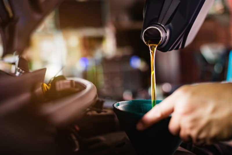 Pouring oil into a funnel