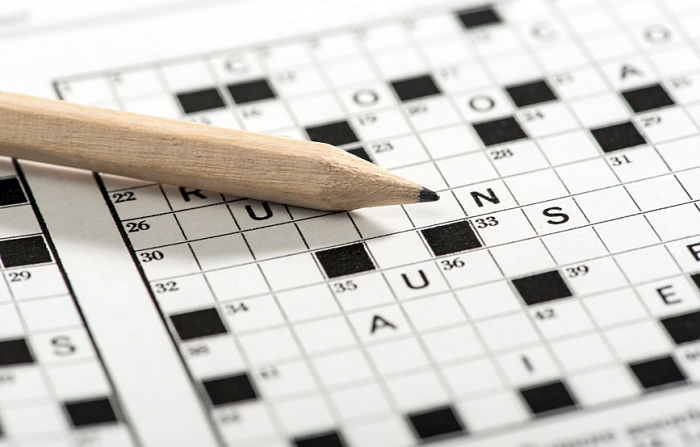 Conceptual Sharpened Pencil on Top of Crossword Puzzle Game Paper in Close up Shot