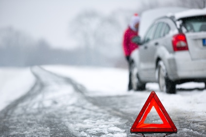 warning triangle with winter car breakdown in background