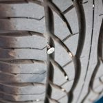 metallic nail in car tyre close up, car tyre repair